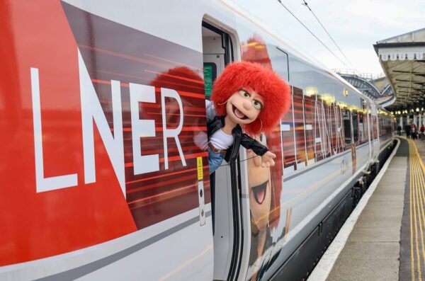 Eleanor the Puppet, leans out of Eleanor the Train, at York Station. As part of the LNER Azuma Eleanor Train launch